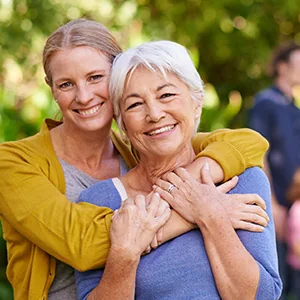 Middle aged daughter hugging mother