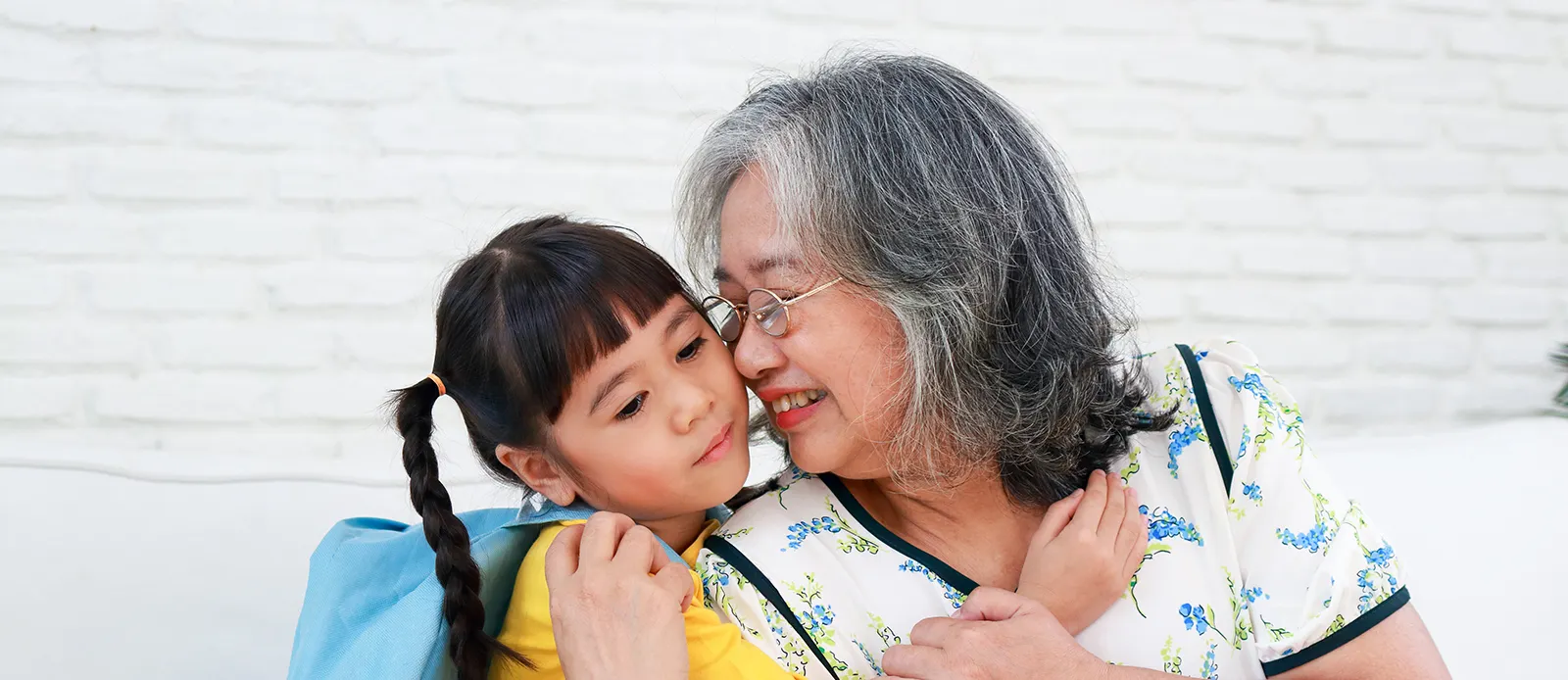 elderly grandmother with cute little granddaughter