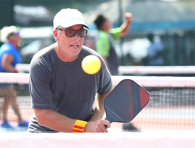 Middle-aged man playing a pickleball tournament