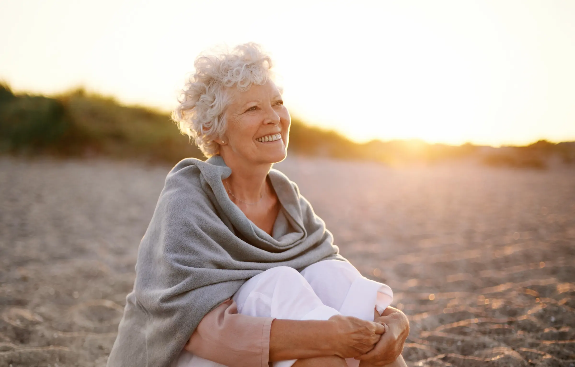 Senior woman sitting on the beach