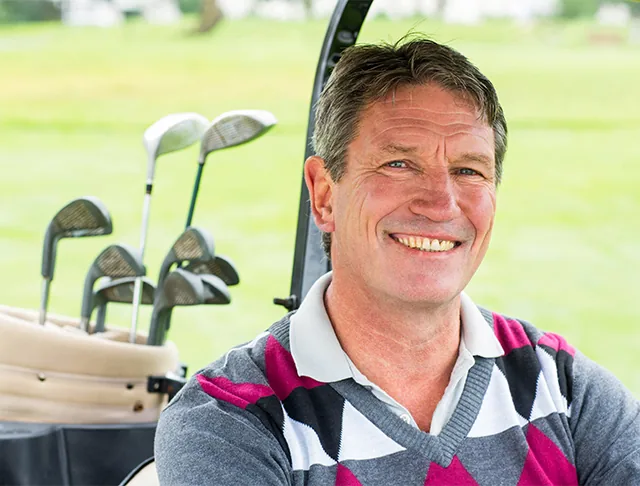 Smiling man in golf cart