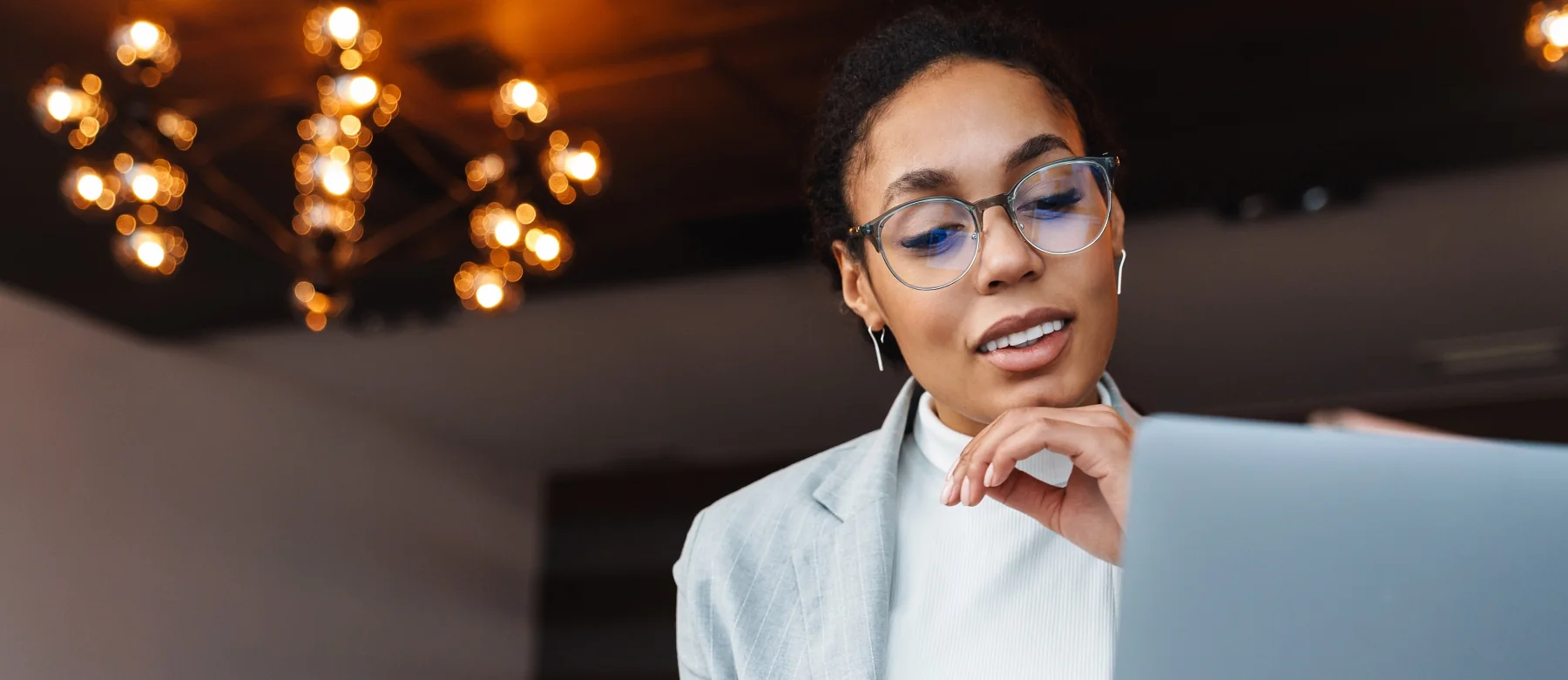 Woman with glasses using a computer to book online